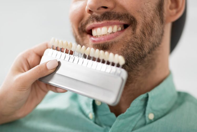 newmarket family dental dentist checks teeth colour of patient